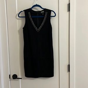 Black suede-look mini dress with silver-studs around the neckline.